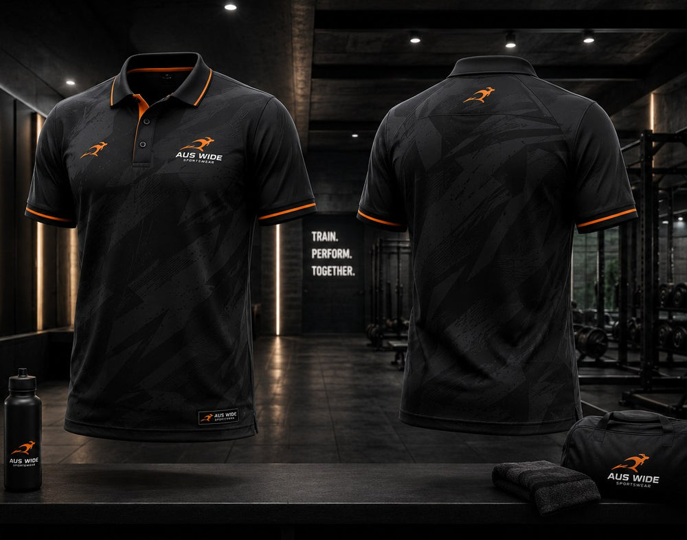 Custom sublimated polo shown front and back in black with a charcoal pattern and orange trim.